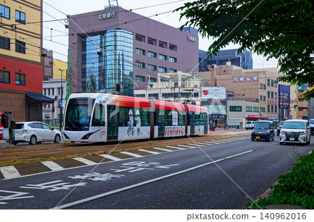 Fukui Railway F1000 series train passing through the Daimyocho area on Chuo-dori Street. Fukui Railway F1000 series train passing through the Daimyocho area on Chuo-dori Street. 140962016