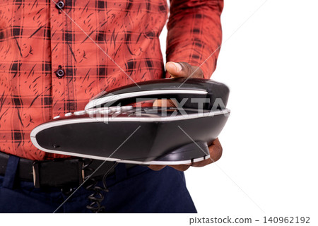 close up of male hand holding telephone. close up of male hand holding telephone. 140962192