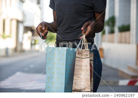 young woman carrying shopping bags. young woman carrying shopping bags. 140962197