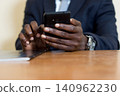 closeup of hands holding a mobile phone. 140962230