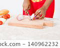 Hands of woman cutting onions. 140962232