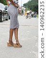 Picture of beautiful legs of a young woman standing in the street. 140962235