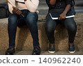 two students sitting and studying outside 140962240