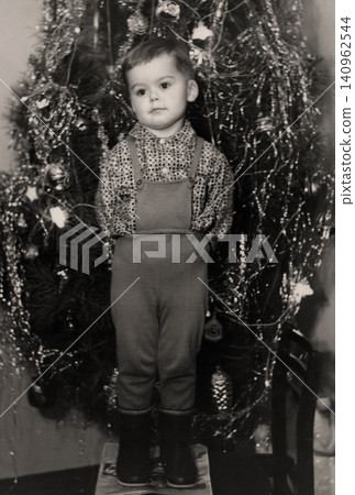 Retro portrait of little boy by Christmas tree, Dnepropetrovsk, Ukrainian SSR, USSR - January 1, 1971 Retro portrait of little boy by Christmas tree, Dnepropetrovsk, Ukrainian SSR, USSR - January 1, 1971 140962544