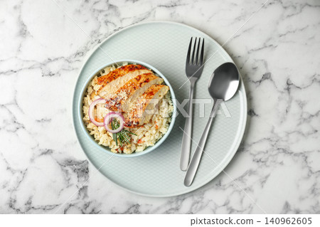 Delicious chicken risotto served on white marble table, top view Delicious chicken risotto served on white marble table, top view 140962605