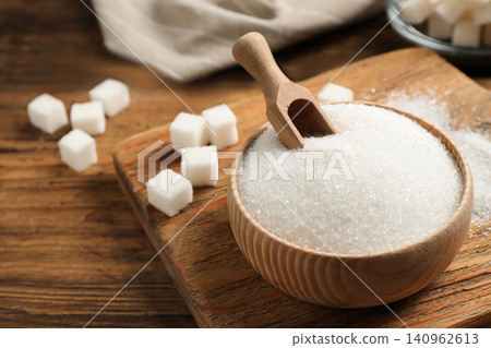 Granulated sugar in bowl on wooden table Granulated sugar in bowl on wooden table 140962613