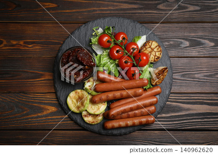 Tasty grilled sausages served on wooden table, top view Tasty grilled sausages served on wooden table, top view 140962620