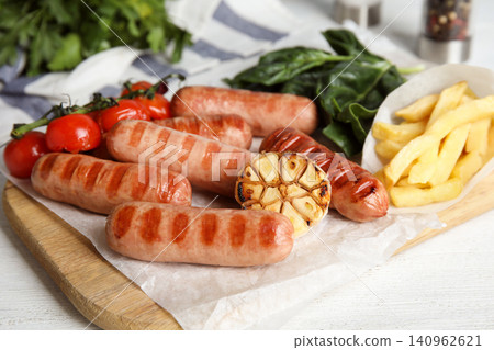 Delicious grilled sausages served on white table Delicious grilled sausages served on white table 140962621