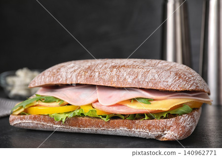Tasty sandwich with ham on black table, closeup Tasty sandwich with ham on black table, closeup 140962771