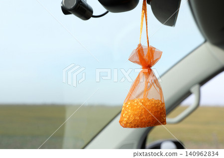 Air freshener hanging in car against windshield. Space for text Air freshener hanging in car against windshield. Space for text 140962834