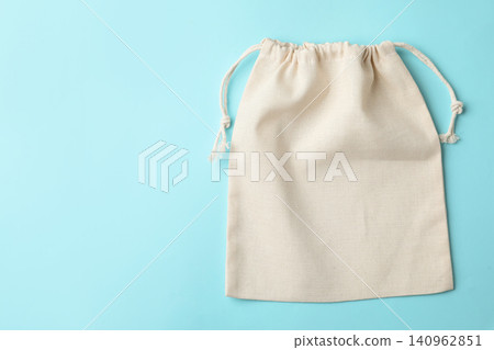 Cotton eco bag on light blue background, top view. Space for text Cotton eco bag on light blue background, top view. Space for text 140962851