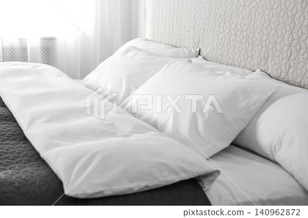 Bed with soft fluffy pillows at home Bed with soft fluffy pillows at home 140962872