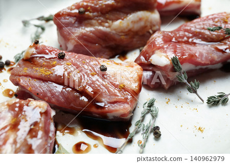 Raw marinated ribs with thyme and peppercorn, closeup Raw marinated ribs with thyme and peppercorn, closeup 140962979