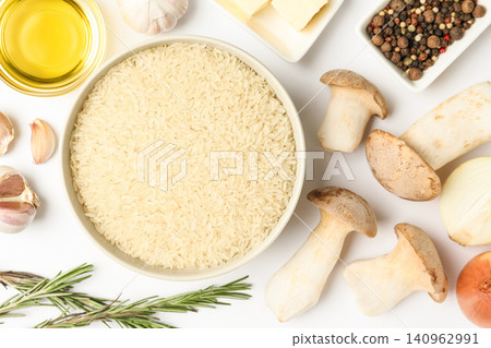 Different ingredients on white background, top view. Risotto recipe Different ingredients on white background, top view. Risotto recipe 140962991