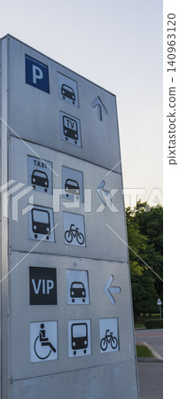 Modern metal parking navigation sign pillar with pictograms for taxi, bus, bicycle, disabled access, and VIP zones. City 140963120