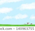 A herd of cows grazing peacefully in a meadow against a backdrop of blue sky. 140963755