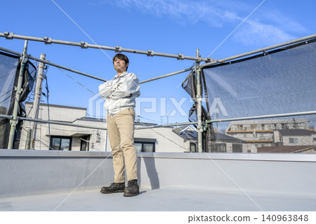 Site supervisor inspects the completed flat roof renovation site. Site supervisor inspects the completed flat roof renovation site. 140963848