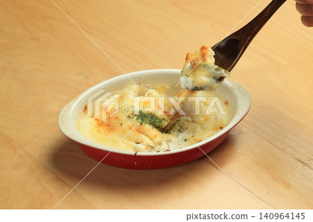 Japanese home-style macaroni gratin served on a wooden table. Japanese home-style macaroni gratin served on a wooden table. 140964145