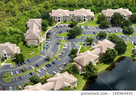 Suburban Florida condos with car parking area, representing family housing and residential planning in the USA Suburban Florida condos with car parking area, representing family housing and residential planning in the USA 140964445