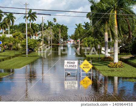 Street under water warning sign. Closed city road because of flooding blocking driving of cars. Consequence of hurricane Milton in Punta Gorda, Florida Street under water warning sign. Closed city road because of flooding blocking driving of cars. Consequence of hurricane Milton in Punta Gorda, Florida 140964458