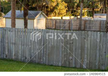 Wooden fence surrounding private property grounds for backyard protection and privacy in southern Florida Wooden fence surrounding private property grounds for backyard protection and privacy in southern Florida 140964515