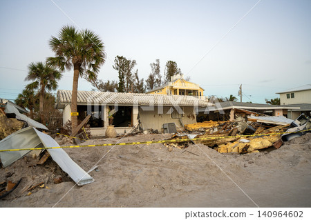 Trash from severely damaged houses after hurricane storm surge. Piles of debris on street side on Manasota key street in Florida. Consequences of natural disaster Trash from severely damaged houses after hurricane storm surge. Piles of debris on street side on Manasota key street in Florida. Consequences of natural disaster 140964602