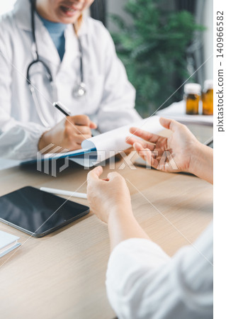 Doctor writing medical notes while patient explains health concerns during clinic consultation, diagnosis, treatment advice, healthcare service, and patient care concept. Doctor writing medical notes while patient explains health concerns during clinic consultation, diagnosis, treatment advice, healthcare service, and patient care concept. 140966582