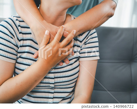 Close up of Asian woman massaging another woman shoulder and arm at home, concept of body pain, muscle soreness, physical therapy, caregiving, and family support. Close up of Asian woman massaging another woman shoulder and arm at home, concept of body pain, muscle soreness, physical therapy, caregiving, and family support. 140966722