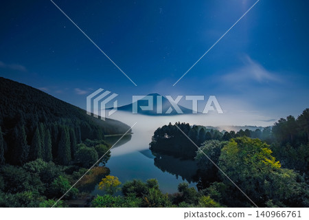 Mount Fuji illuminated by moonlight and Lake Tanuki enveloped in a sea of clouds, under a starry sky. Mount Fuji illuminated by moonlight and Lake Tanuki enveloped in a sea of clouds, under a starry sky. 140966761