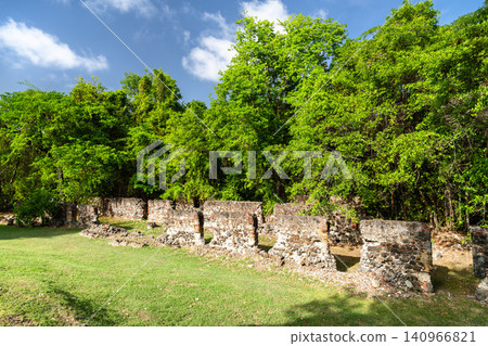 Historic stone wall ruins of Chateau Dubuc surrounded by lush green forest in Caravelle Peninsula, Martinique, a French Caribbean Island Historic stone wall ruins of Chateau Dubuc surrounded by lush green forest in Caravelle Peninsula, Martinique, a French Caribbean Island 140966821