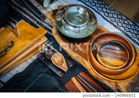 An overview of carefully selected camping gear, including wooden tableware and stainless steel cookware. An overview of carefully selected camping gear, including wooden tableware and stainless steel cookware. 140966851