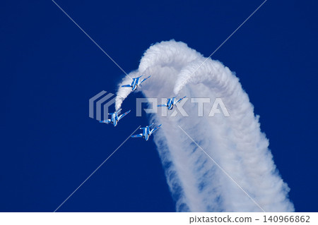 The Blue Impulse aerobatic team takes off, drawing a trail of white smoke across the blue sky. The Blue Impulse aerobatic team takes off, drawing a trail of white smoke across the blue sky. 140966862