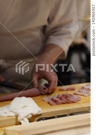 Chef Slicing Fresh Meat on Wooden Board Chef Slicing Fresh Meat on Wooden Board 140966987