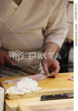 Chef Preparing Fish on Wooden Cutting Board Chef Preparing Fish on Wooden Cutting Board 140967013