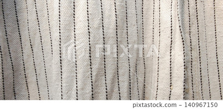 Fabric texture with fine white lines in a vertical pattern. 140967150