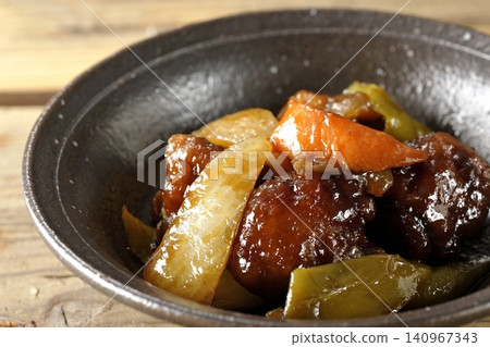 A single serving of sweet and sour pork with black vinegar, containing carrots, onions, bell peppers, and pork shoulder. A single serving of sweet and sour pork with black vinegar, containing carrots, onions, bell peppers, and pork shoulder. 140967343