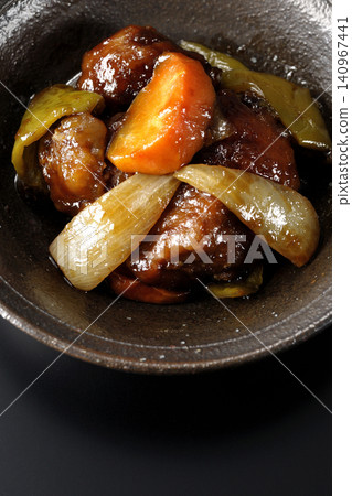 Black vinegar sweet and sour pork containing carrots, onions, bell peppers, and pork shoulder, photographed individually against a black background. Black vinegar sweet and sour pork containing carrots, onions, bell peppers, and pork shoulder, photographed individually against a black background. 140967441