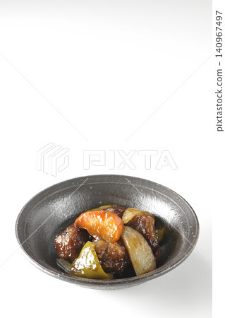 A single serving of sweet and sour pork with black vinegar, containing carrots, onions, bell peppers, and pork shoulder, photographed against a white background. A single serving of sweet and sour pork with black vinegar, containing carrots, onions, bell peppers, and pork shoulder, photographed against a white background. 140967497
