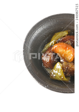 A single serving of sweet and sour pork with black vinegar, containing carrots, onions, bell peppers, and pork shoulder, photographed against a white background. A single serving of sweet and sour pork with black vinegar, containing carrots, onions, bell peppers, and pork shoulder, photographed against a white background. 140967515