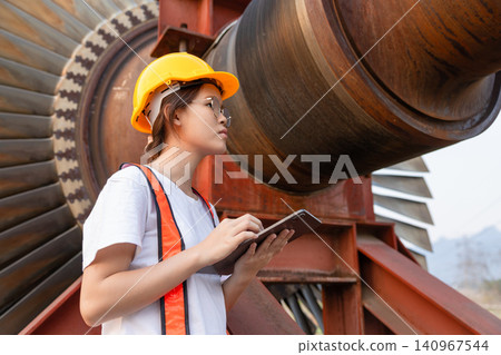Young Asian engineer teen woman working service power plant turbine fan blade electrical generator Young Asian engineer teen woman working service power plant turbine fan blade electrical generator 140967544