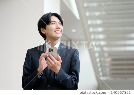 一位正在操作智慧型手機的亞洲商人 140967591
