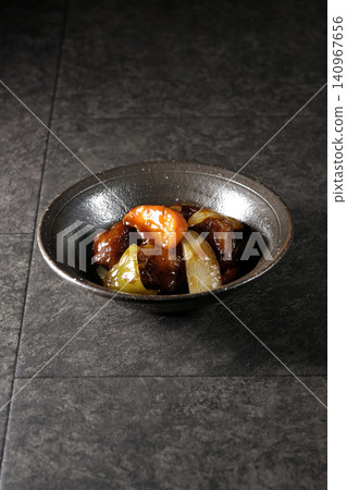 A single serving of sweet and sour pork with black vinegar, containing carrots, onions, bell peppers, and pork shoulder. A single serving of sweet and sour pork with black vinegar, containing carrots, onions, bell peppers, and pork shoulder. 140967656