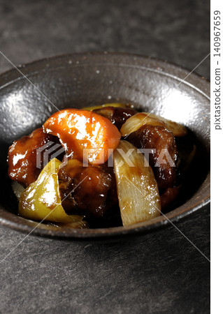 A single serving of sweet and sour pork with black vinegar, containing carrots, onions, bell peppers, and pork shoulder. A single serving of sweet and sour pork with black vinegar, containing carrots, onions, bell peppers, and pork shoulder. 140967659