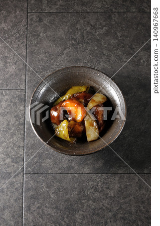 A single serving of sweet and sour pork with black vinegar, containing carrots, onions, bell peppers, and pork shoulder. A single serving of sweet and sour pork with black vinegar, containing carrots, onions, bell peppers, and pork shoulder. 140967668