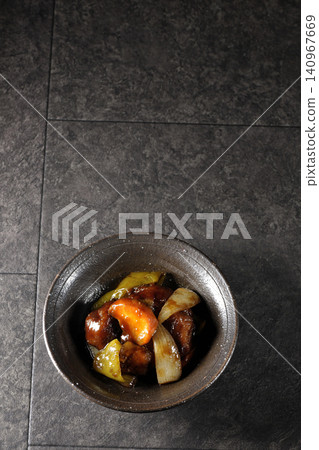 A single serving of sweet and sour pork with black vinegar, containing carrots, onions, bell peppers, and pork shoulder. A single serving of sweet and sour pork with black vinegar, containing carrots, onions, bell peppers, and pork shoulder. 140967669