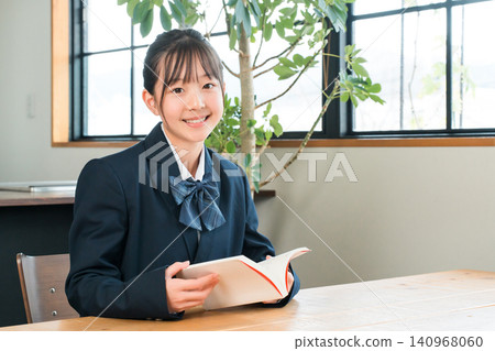 Elementary, middle, and high school girls in school uniforms studying at home (reading). Elementary, middle, and high school girls in school uniforms studying at home (reading). 140968060