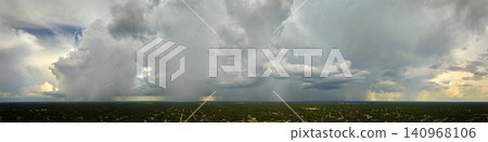 Landscape of dark ominous clouds forming on stormy sky during heavy thunderstorm over rural town area Landscape of dark ominous clouds forming on stormy sky during heavy thunderstorm over rural town area 140968106