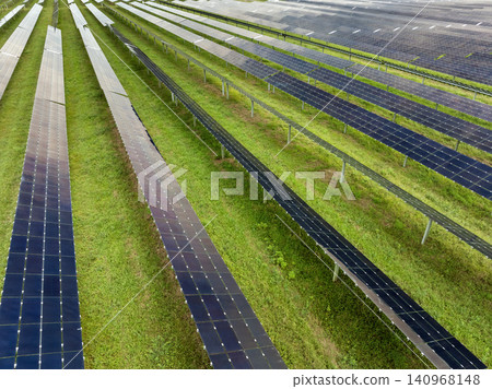 View from above of photovoltaic power plant with many rows of solar panels for producing clean electrical energy. Concept of renewable electricity with no air pollution View from above of photovoltaic power plant with many rows of solar panels for producing clean electrical energy. Concept of renewable electricity with no air pollution 140968148