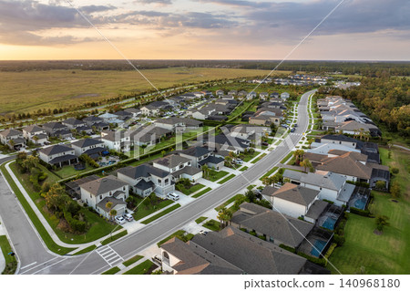 Gated community with expensive houses between green palm trees in southwest Florida. Premium housing development in the USA Gated community with expensive houses between green palm trees in southwest Florida. Premium housing development in the USA 140968180