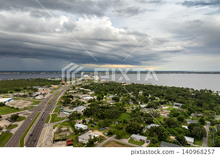Intense thunderstorm above Charlotte Harbor, Florida. Rainwater falling from storm clouds onto coastal neighborhoods. Intense thunderstorm above Charlotte Harbor, Florida. Rainwater falling from storm clouds onto coastal neighborhoods. 140968257